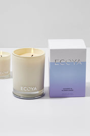 A model wearing the Madison Jar Coconut And Elderflower Candle in colour Coconut, from the front, showing the whole outfit