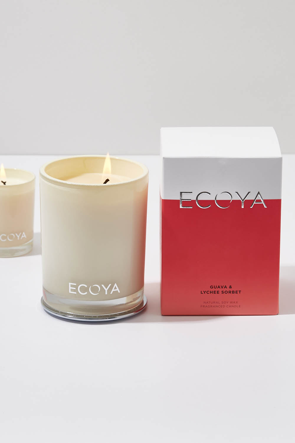 A model wearing the Madison Jar Guava And Lychee Candle in colour GuavaLyche (White), from the front, showing the whole outfit
