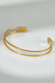 A model wearing the Faith Like A Mustard Seed Cuff Bracelet in colour Gold (Metallics), from the front, showing the whole outfit