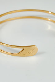 A model wearing the Faith Like A Mustard Seed Cuff Bracelet in colour Gold (Metallics), from the front, showing the whole outfit