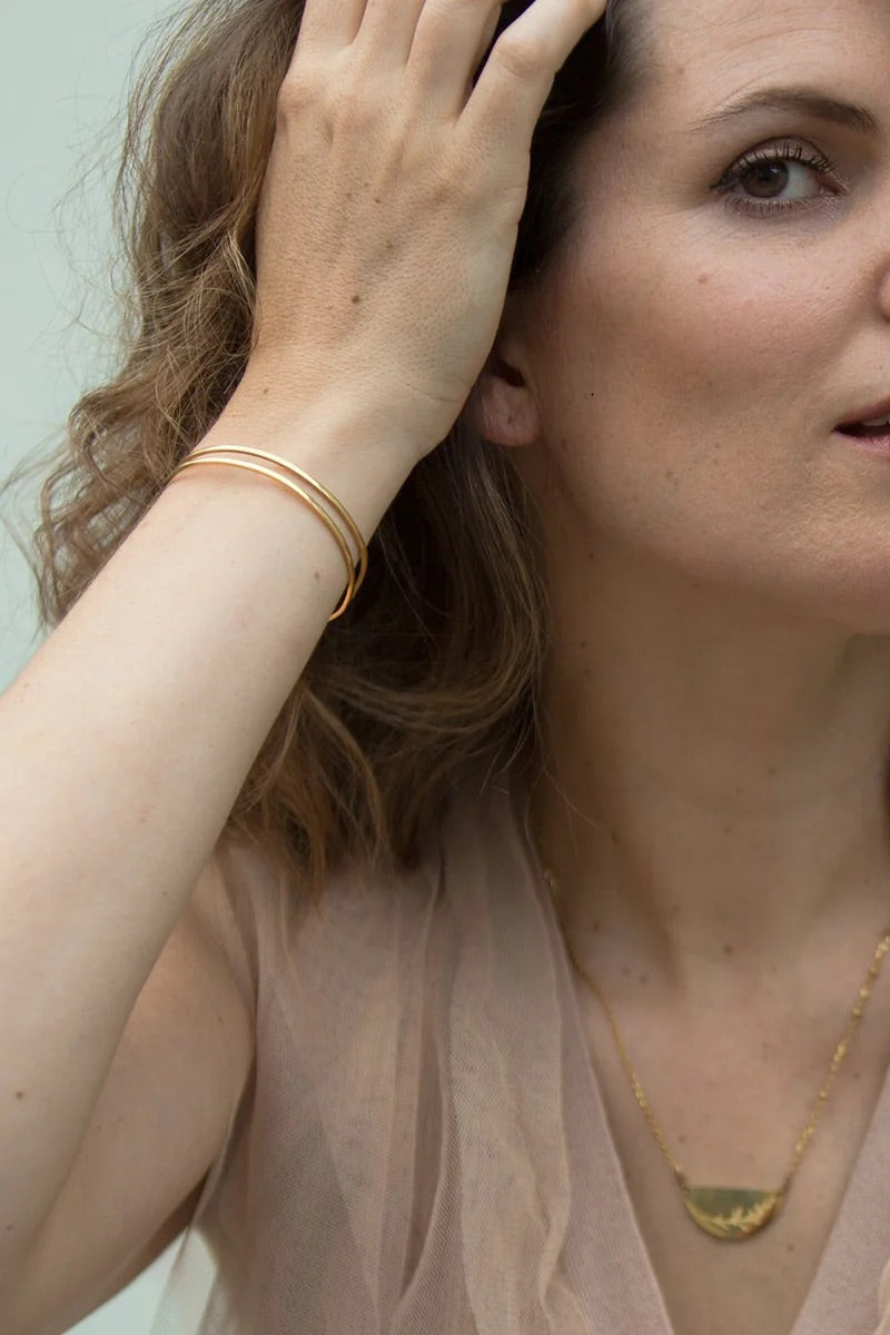 A model wearing the Faith Like A Mustard Seed Cuff Bracelet in colour Gold (Metallics), from the front, showing the whole outfit