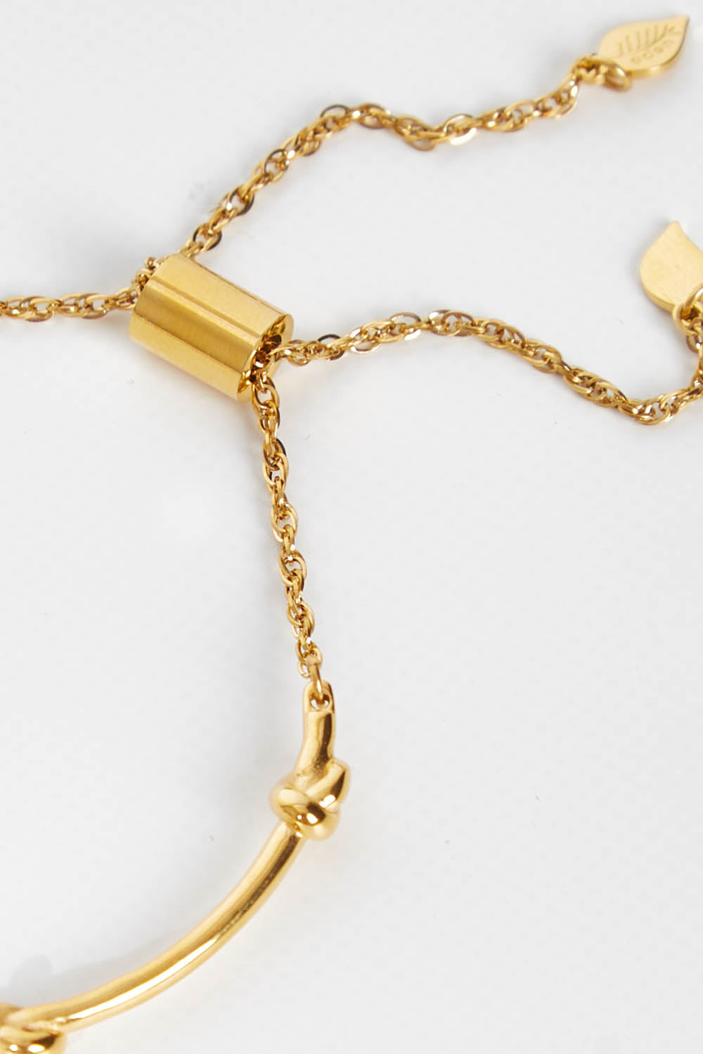 A model wearing size OneSize of the Knots Of Freedom Bracelet in colour Gold (Metallics), from the front, showing the whole outfit