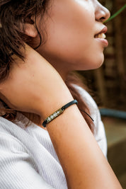A model wearing the Light Triumphs Over Darkness Vegan Leather Bracelet in colour Blue (Blue), from the front, showing the whole outfit