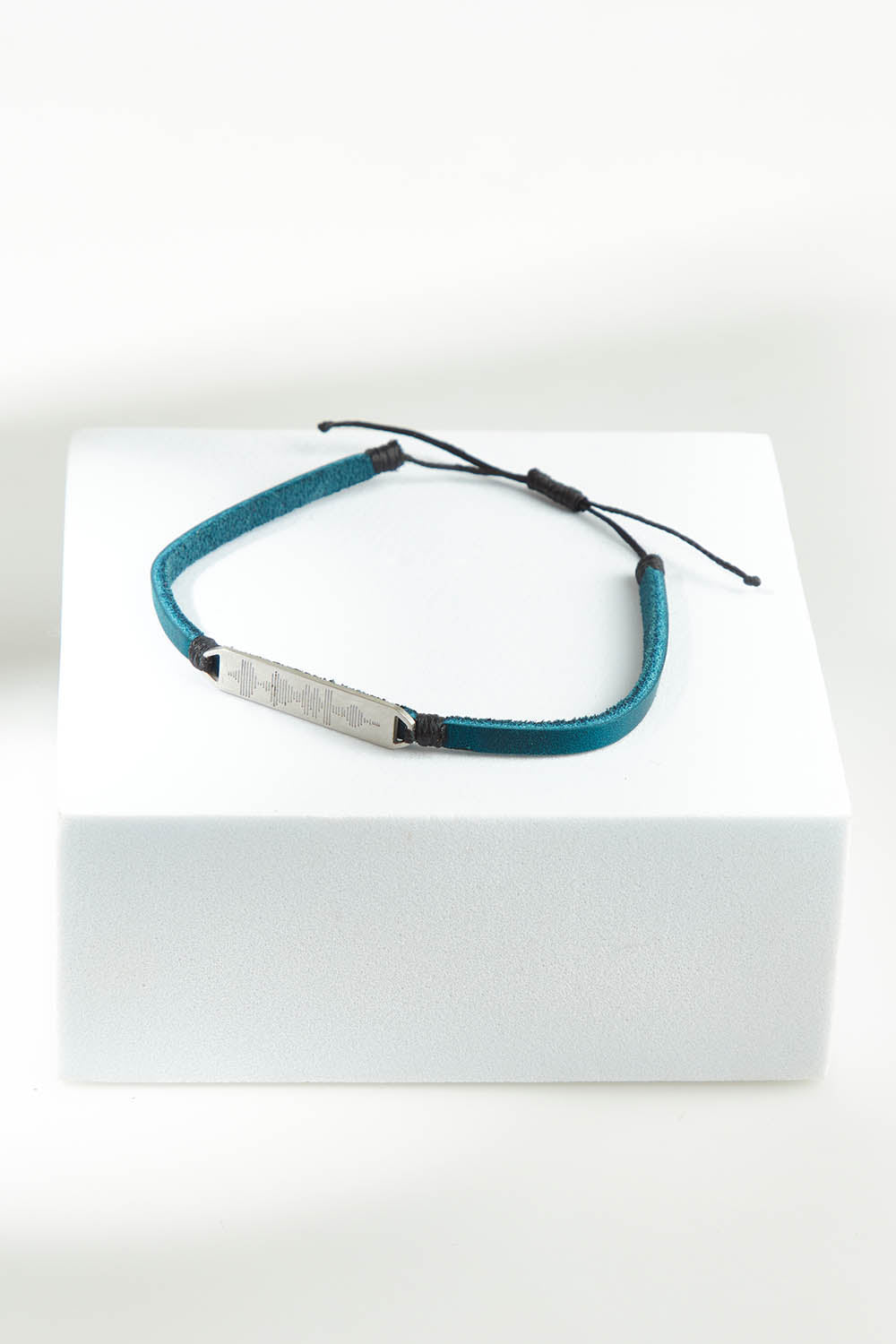 A model wearing the Light Triumphs Over Darkness Vegan Leather Bracelet in colour Blue (Blue), from the front, showing the whole outfit