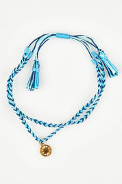 A model wearing the Light Triumphs Over Darkness Woven Bracelet in colour Blue (Blue), from the front, showing the whole outfit