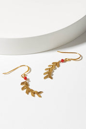 A model wearing size OneSize of the Desert Wild Flower Earrings in colour Gold (Metallics), from the front, showing the whole outfit