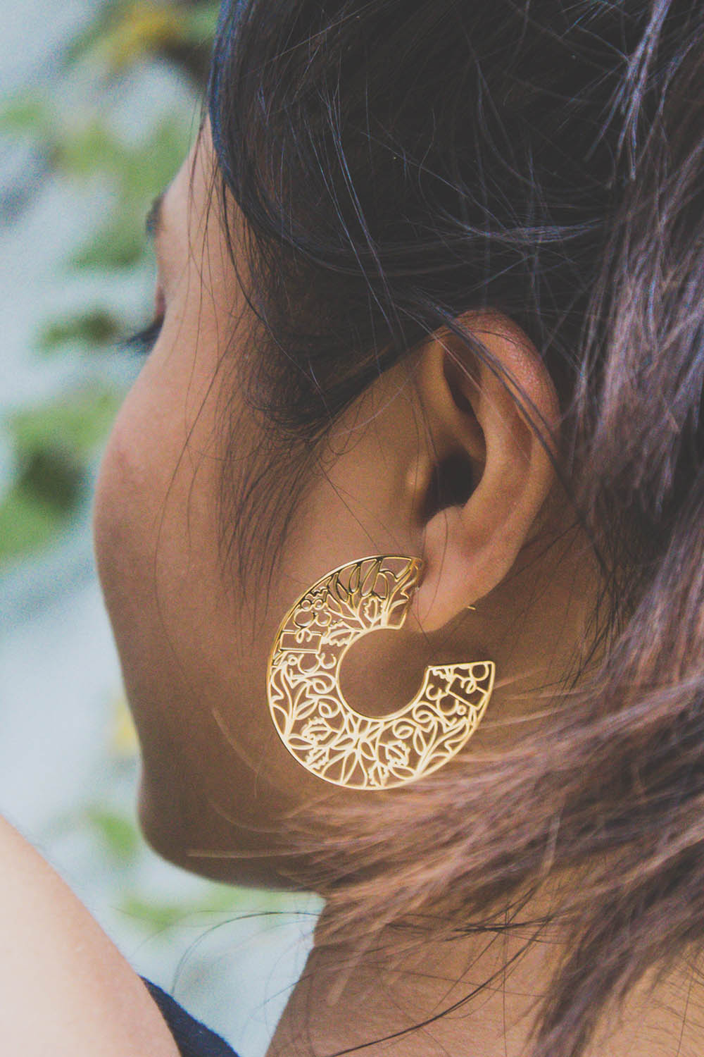 A model wearing the I Am Brave Earrings in colour Gold (Metallics), from the front, showing the whole outfit