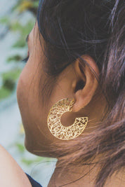 A model wearing the I Am Brave Earrings in colour Gold (Metallics), from the front, showing the whole outfit