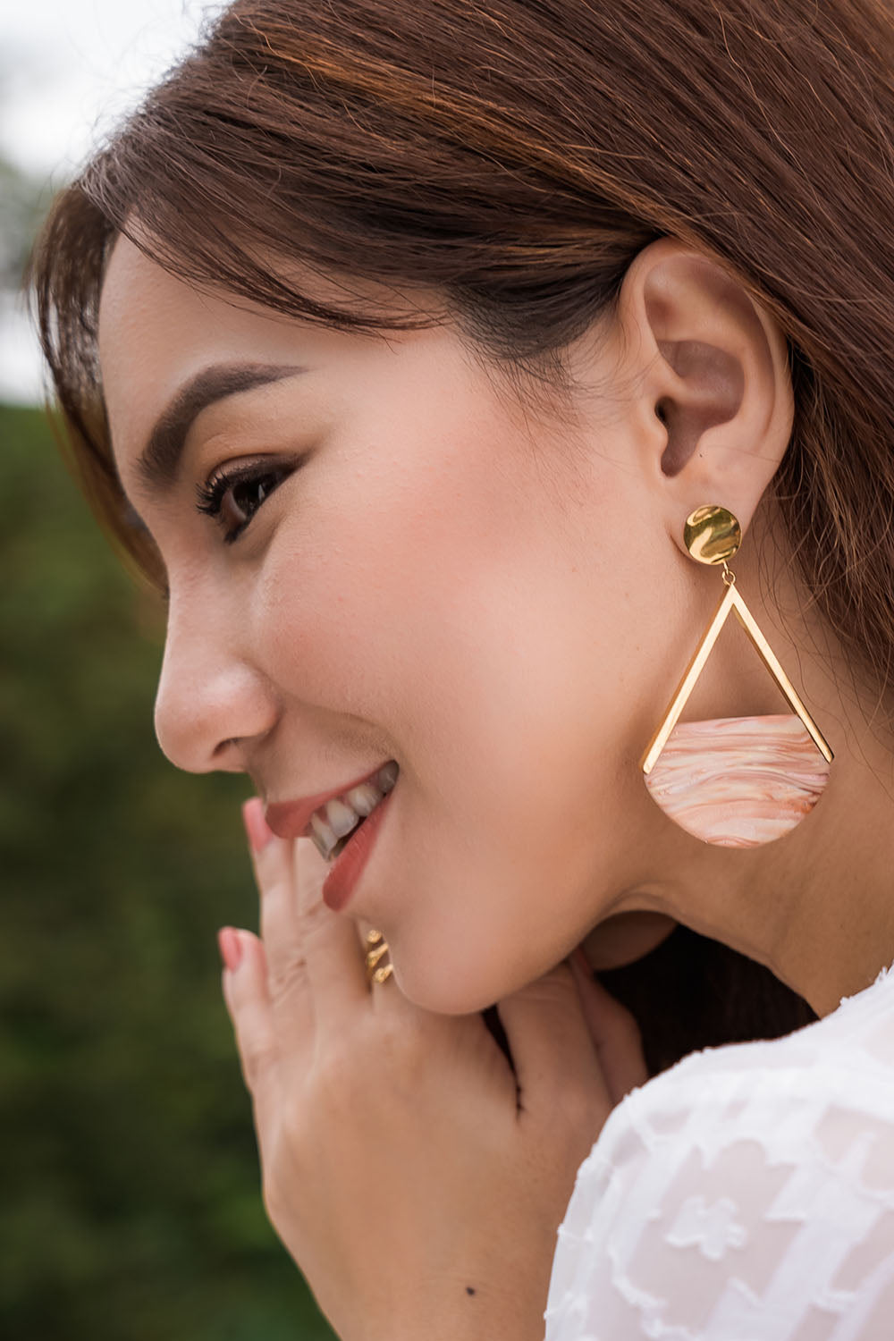 A model wearing the Desert Sand Earrings in colour Gold (Metallics), from the front, showing the whole outfit