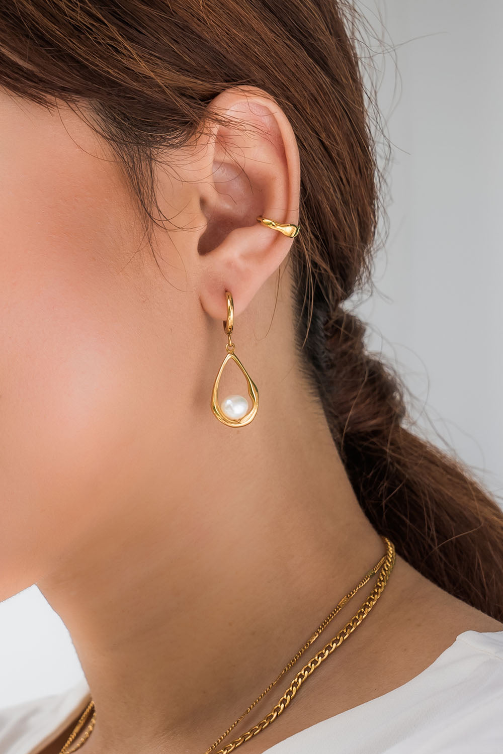 A model wearing the Milk And Honey Drop Earrings in colour Gold (Metallics), from the front, showing the whole outfit