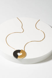 A model wearing size S of the Committed Necklace in colour Gold (Metallics), from the front, showing the whole outfit