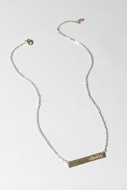 A model wearing size OneSize of the Speak Up Bar Necklace in colour Silver (Metallics), from the front, showing the whole outfit