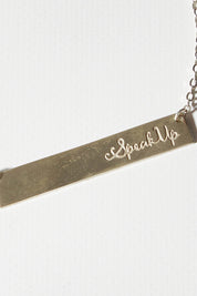 A model wearing size OneSize of the Speak Up Bar Necklace in colour Silver (Metallics), from the front, showing the whole outfit