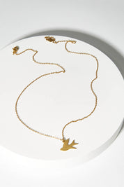 A model wearing size OneSize of the Song Of Freedom Necklace in colour Gold (Metallics), from the front, showing the whole outfit
