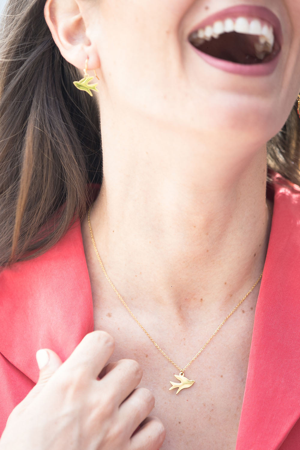 A model wearing the Song Of Freedom Necklace in colour Gold (Metallics), from the front, showing the whole outfit