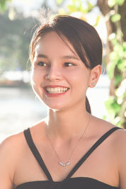 A model wearing the Time To Rise Necklace in colour Silver (Metallics), from the front, showing the whole outfit