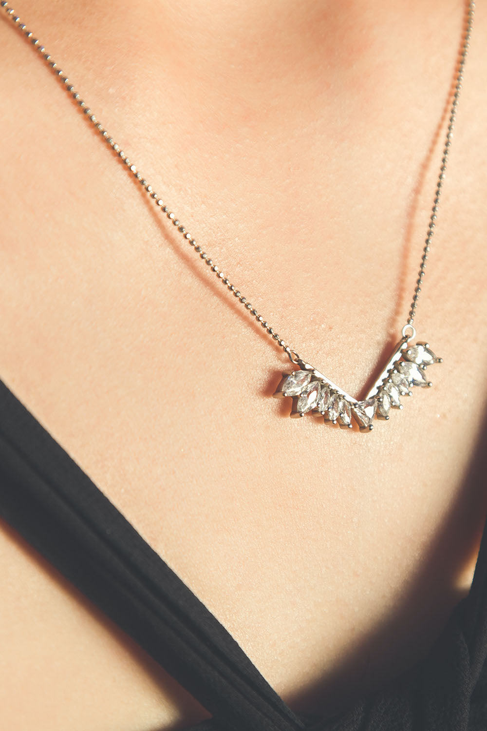 A model wearing the Time To Rise Necklace in colour Silver (Metallics), from the front, showing the whole outfit