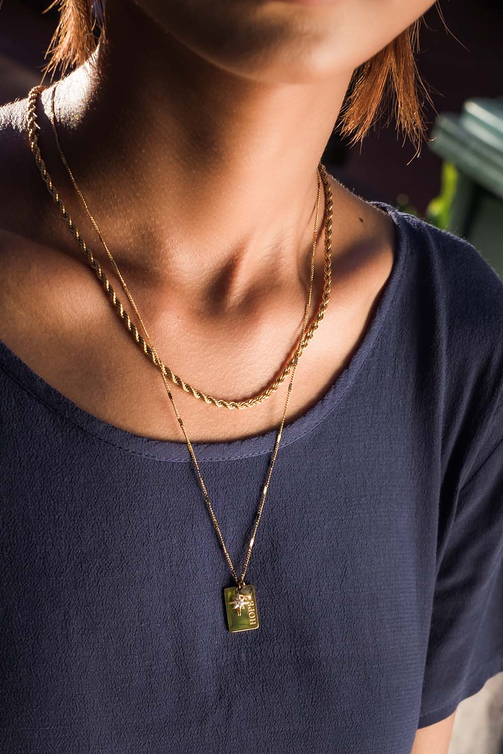 A model wearing the Statement Necklace Set in colour Gold (Metallics), from the front, showing the whole outfit
