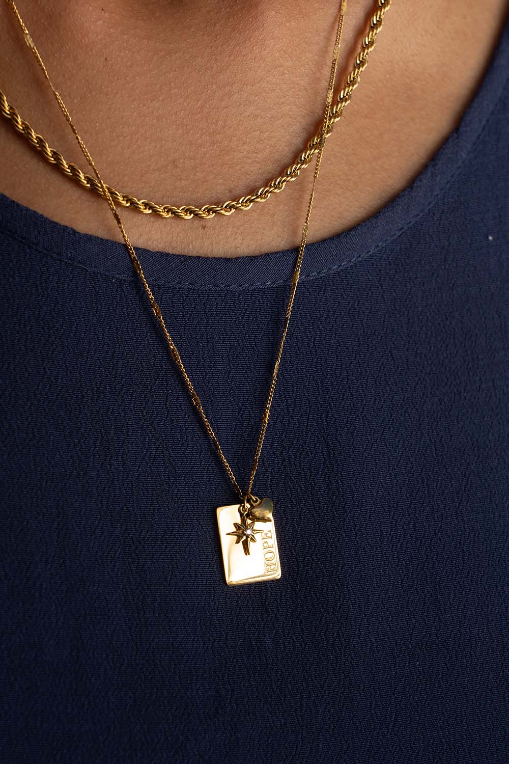A model wearing the Statement Necklace Set in colour Gold (Metallics), from the front, showing the whole outfit