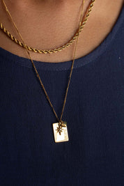 A model wearing the Statement Necklace Set in colour Gold (Metallics), from the front, showing the whole outfit