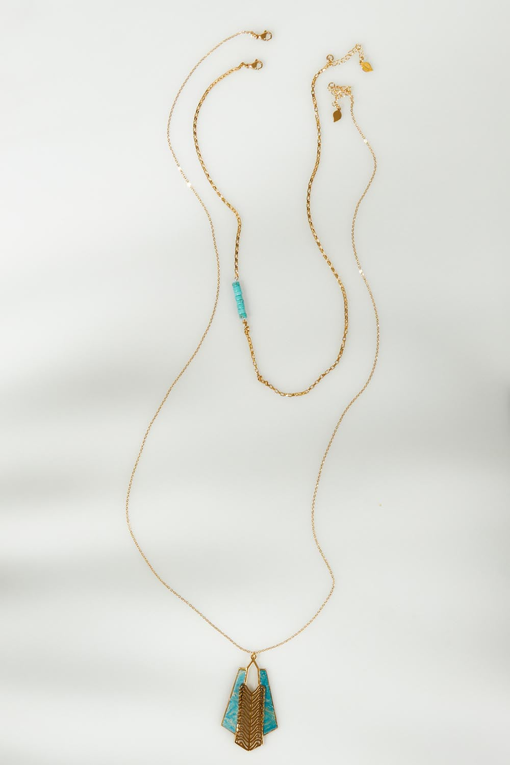A model wearing the Parting Waters Necklace Set in colour Bluegold (Metallics), from the front, showing the whole outfit