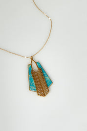 A model wearing the Parting Waters Necklace Set in colour Bluegold (Metallics), from the front, showing the whole outfit