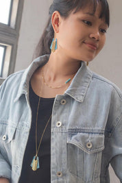 A model wearing the Parting Waters Necklace Set in colour Bluegold (Metallics), from the front, showing the whole outfit