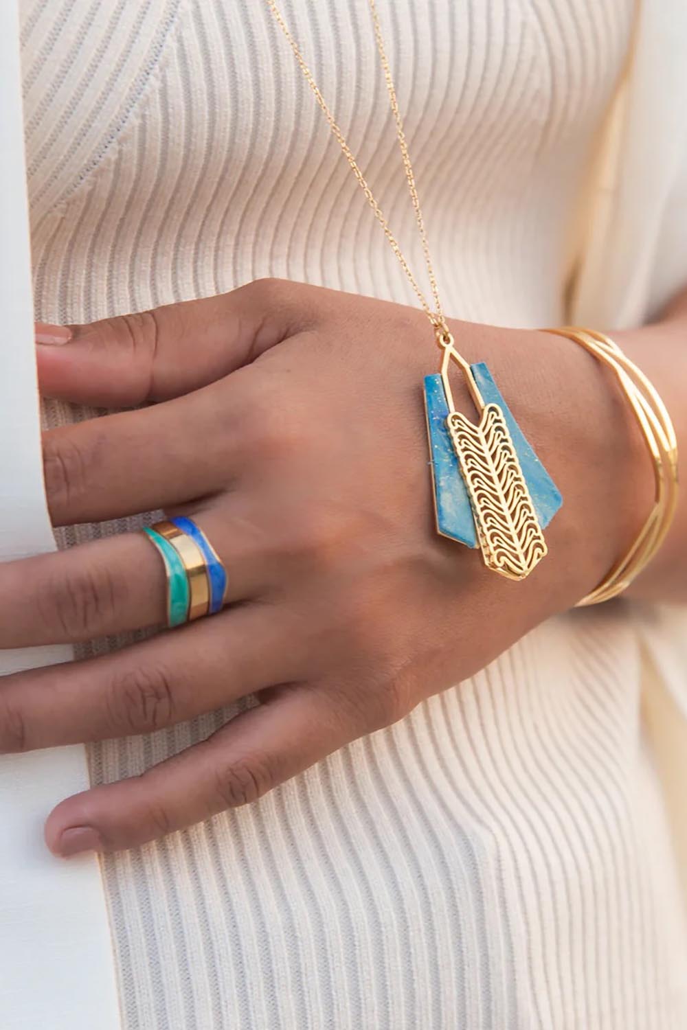 A model wearing the Parting Waters Necklace Set in colour Bluegold (Metallics), from the front, showing the whole outfit