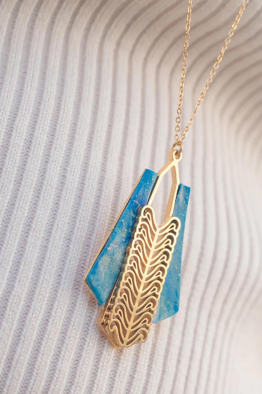 A model wearing the Parting Waters Necklace Set in colour Bluegold (Metallics), from the front, showing the whole outfit