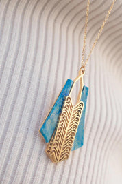 A model wearing the Parting Waters Necklace Set in colour Bluegold (Metallics), from the front, showing the whole outfit