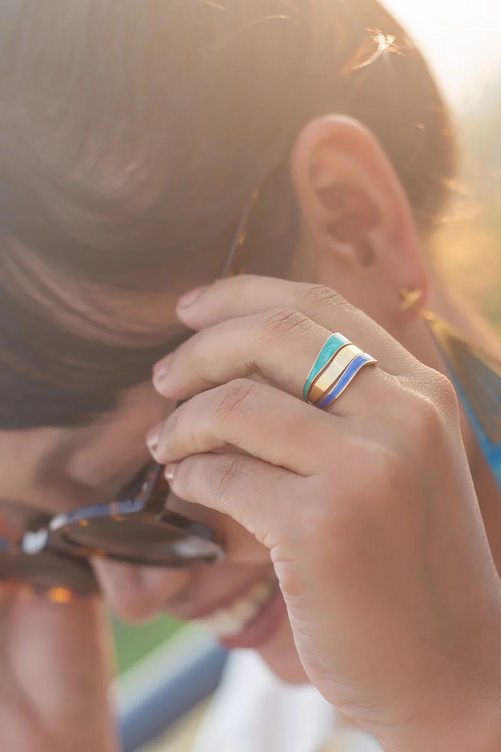 A model wearing the Parting Waters Ring in colour Bluegold (Metallics), from the front, showing the whole outfit