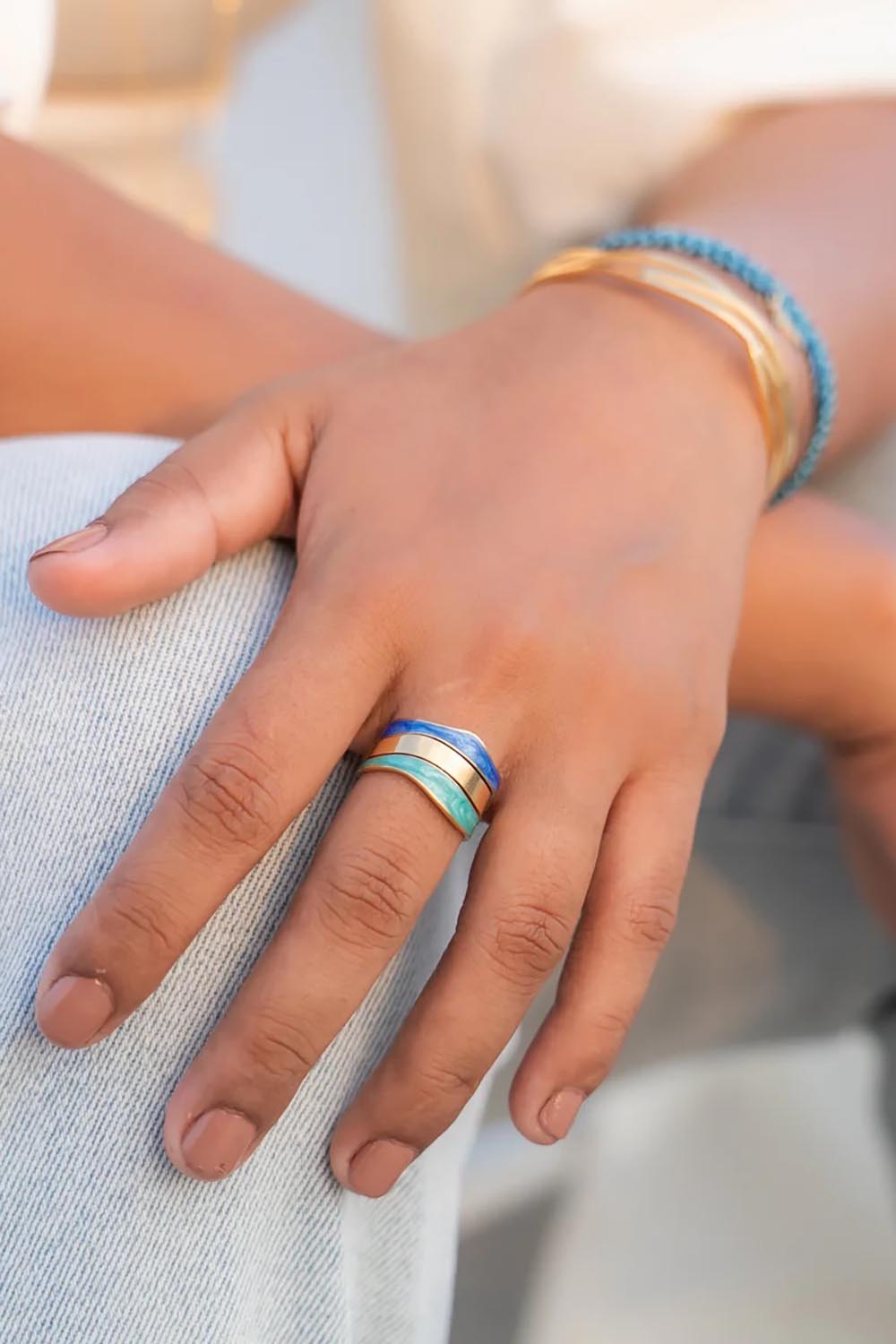 A model wearing the Parting Waters Ring in colour Bluegold (Metallics), from the front, showing the whole outfit
