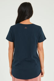 Model Katie wearing size 10 of the Seeing Stars Tee in colour Drksapp (Blue), from the back