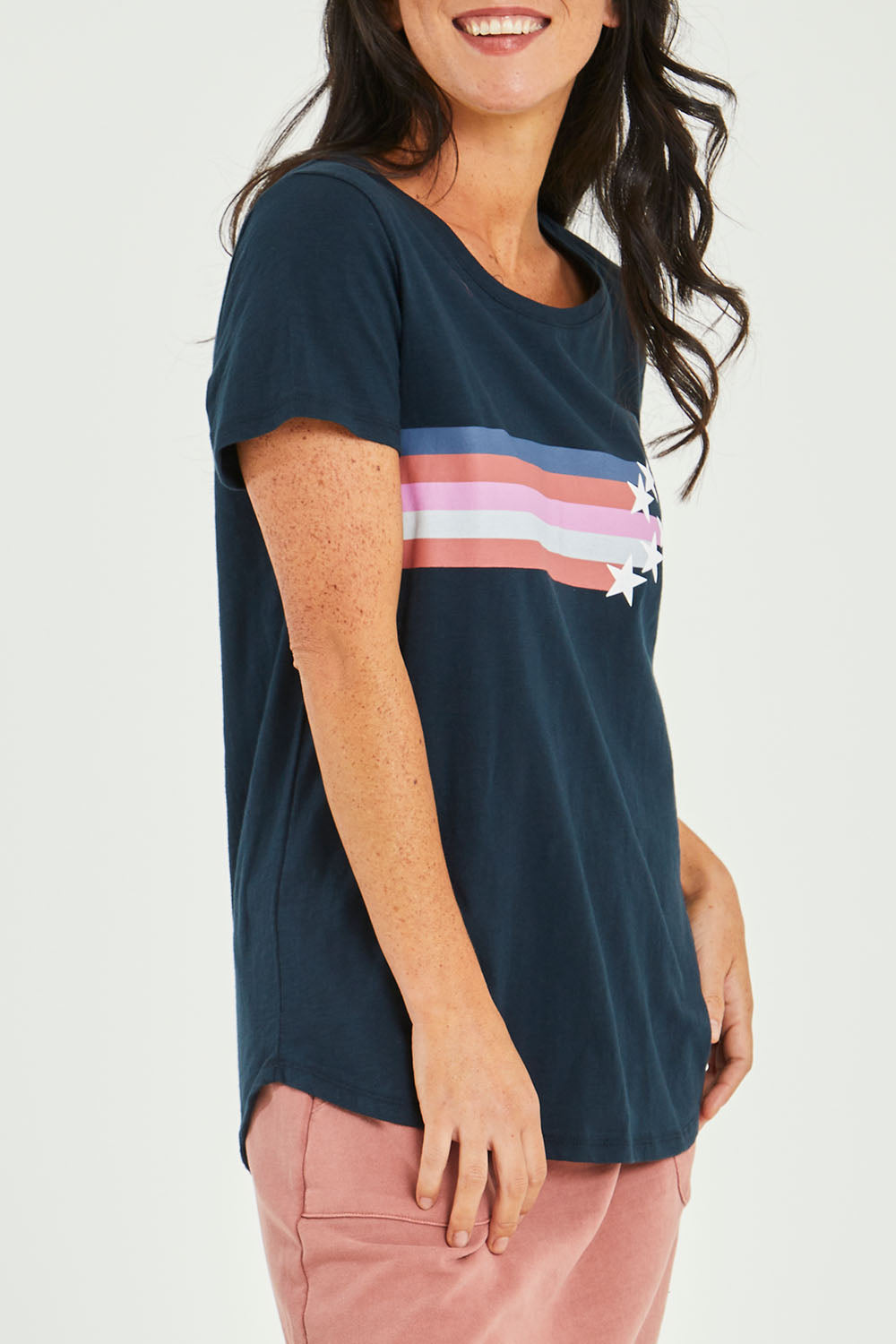 Model Katie wearing size 10 of the Seeing Stars Tee in colour Drksapp (Blue), from the front, cropped image