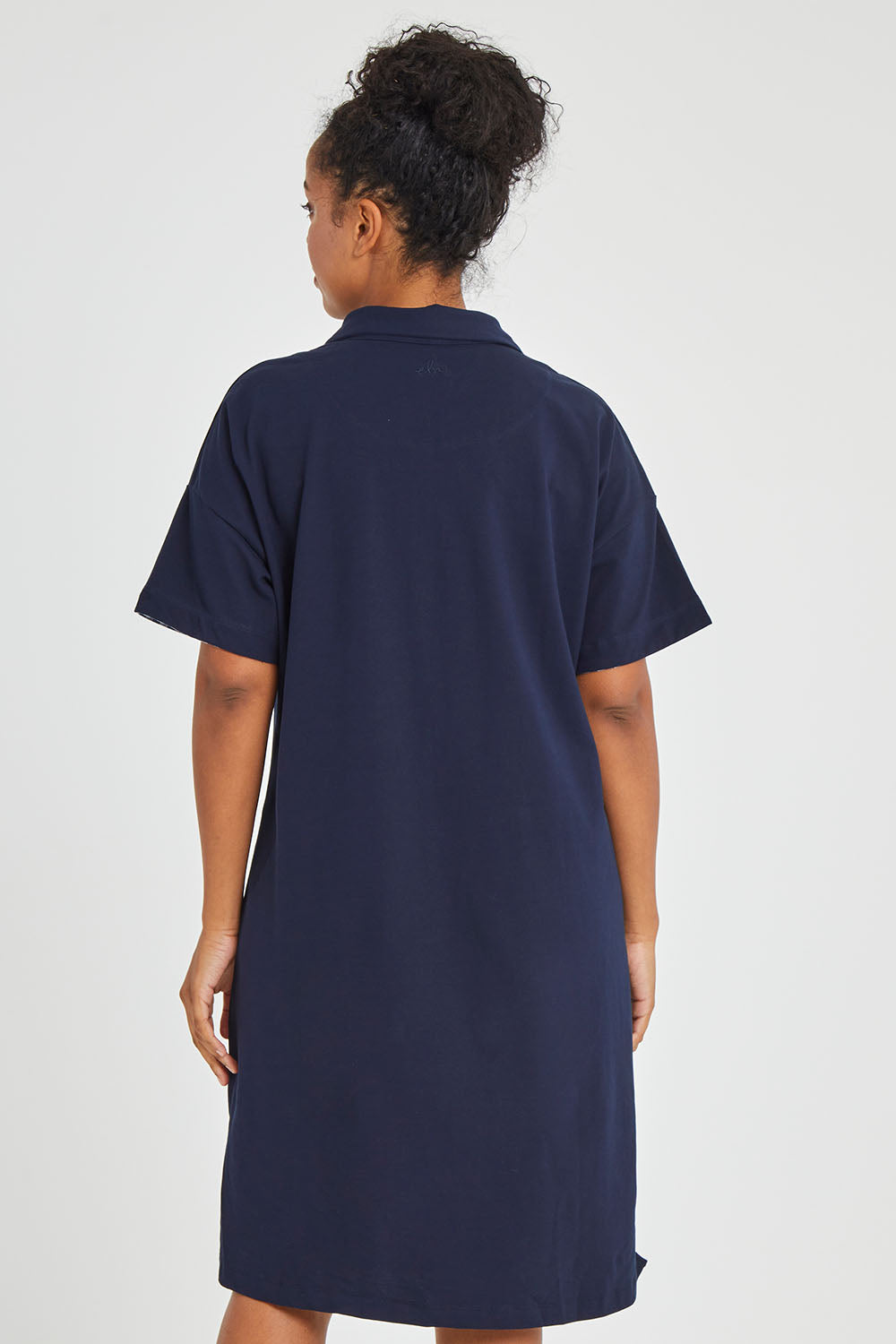 Model Noli wearing size 14 of the Grace Polo Dress in colour Drksapp (Blue), from the back