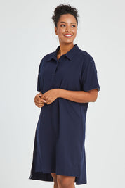 Model Noli wearing size 14 of the Grace Polo Dress in colour Drksapp (Blue), from the front, cropped image