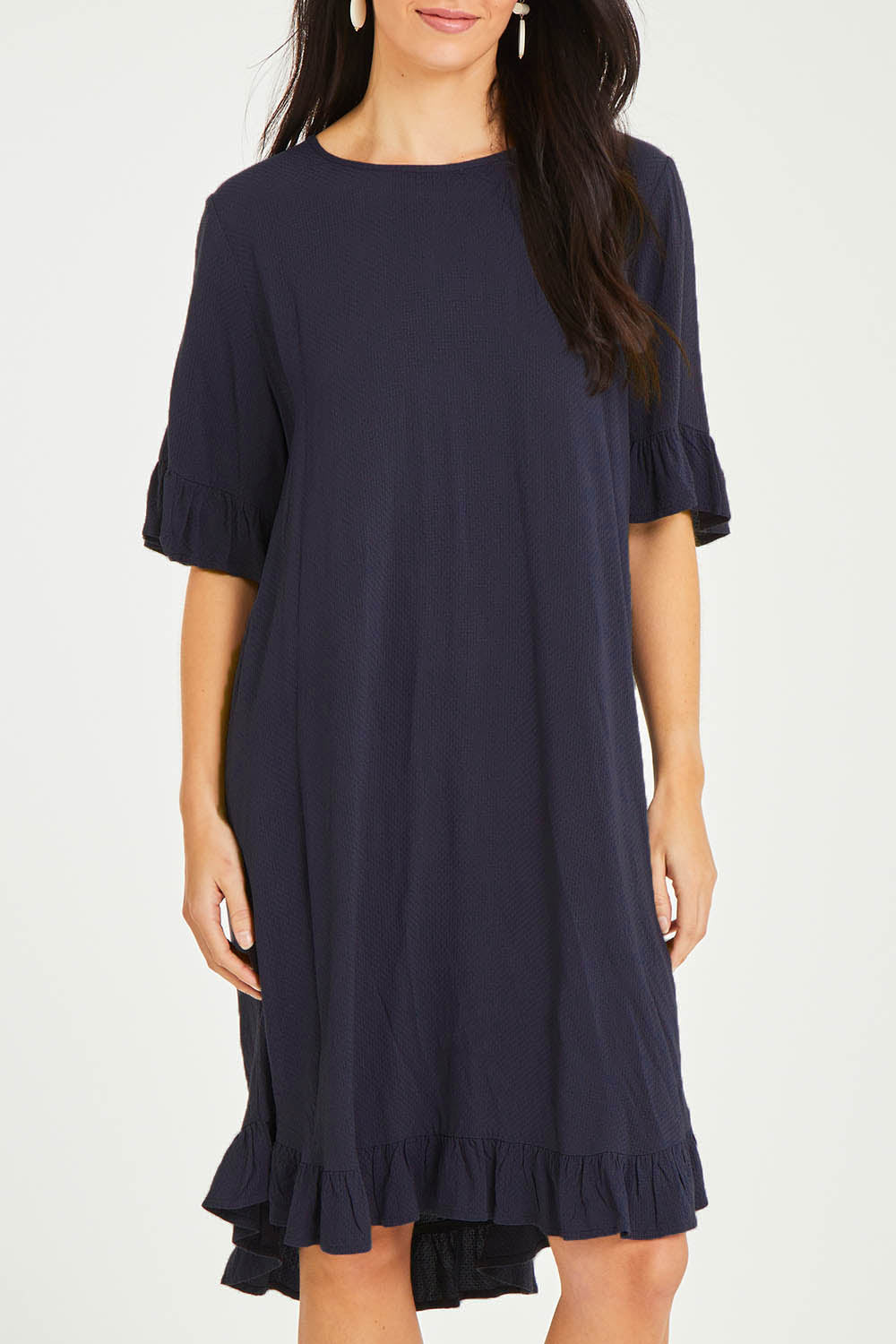 Model Stacey wearing size 10 of the Kiara Dress in colour Dsapphi (Blue), from the front, cropped image