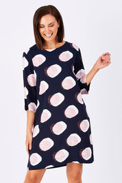 Model Perrie wearing size 10 of the Dandelion Dress in colour NavyDandel (Blue), from the front, cropped image