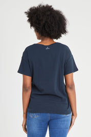 Model Aiyana wearing size 10 of the Lucky In Love Tee in colour Drksapp (Blue), from the back
