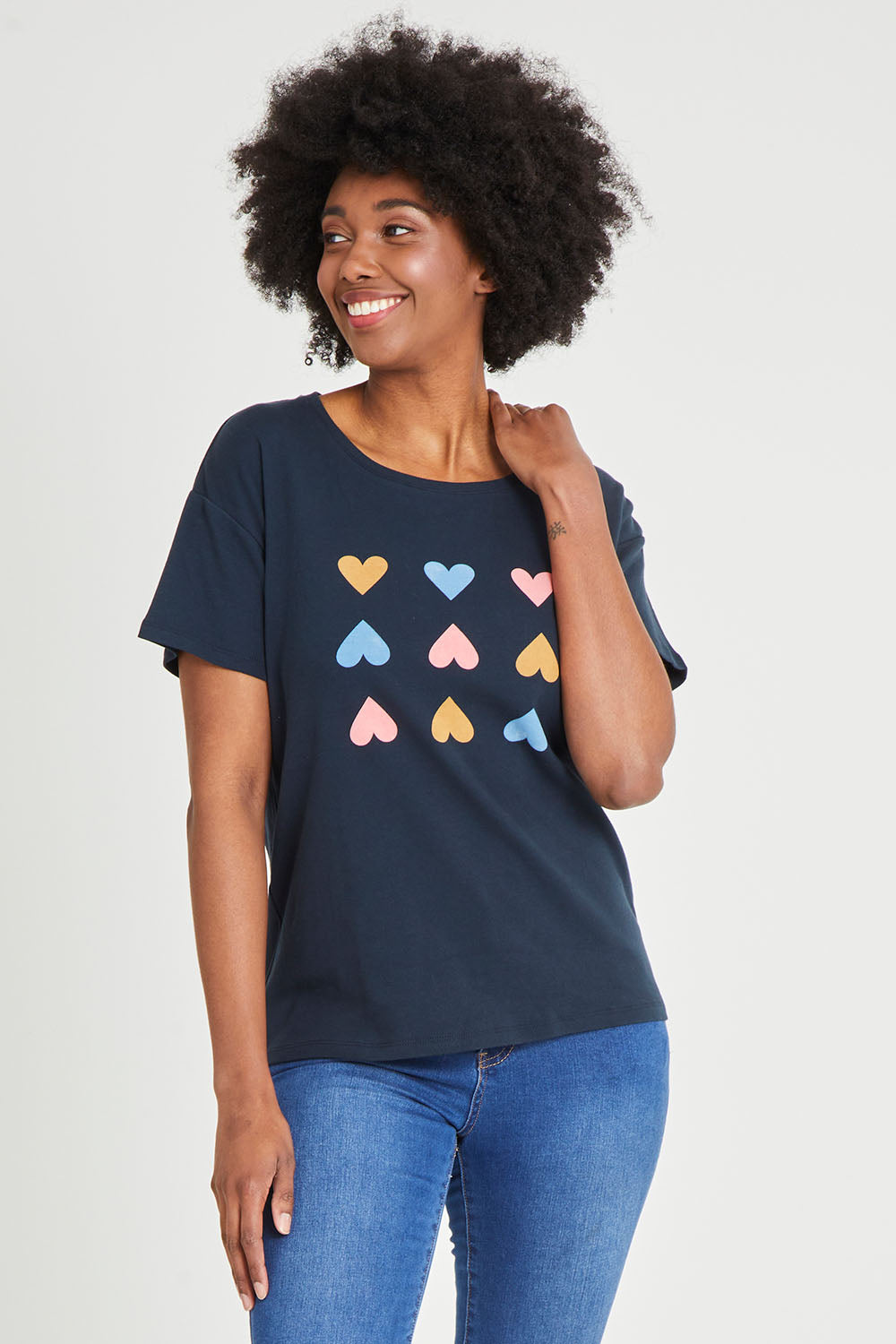 Model Aiyana wearing size 10 of the Lucky In Love Tee in colour Drksapp (Blue), from the front, cropped image