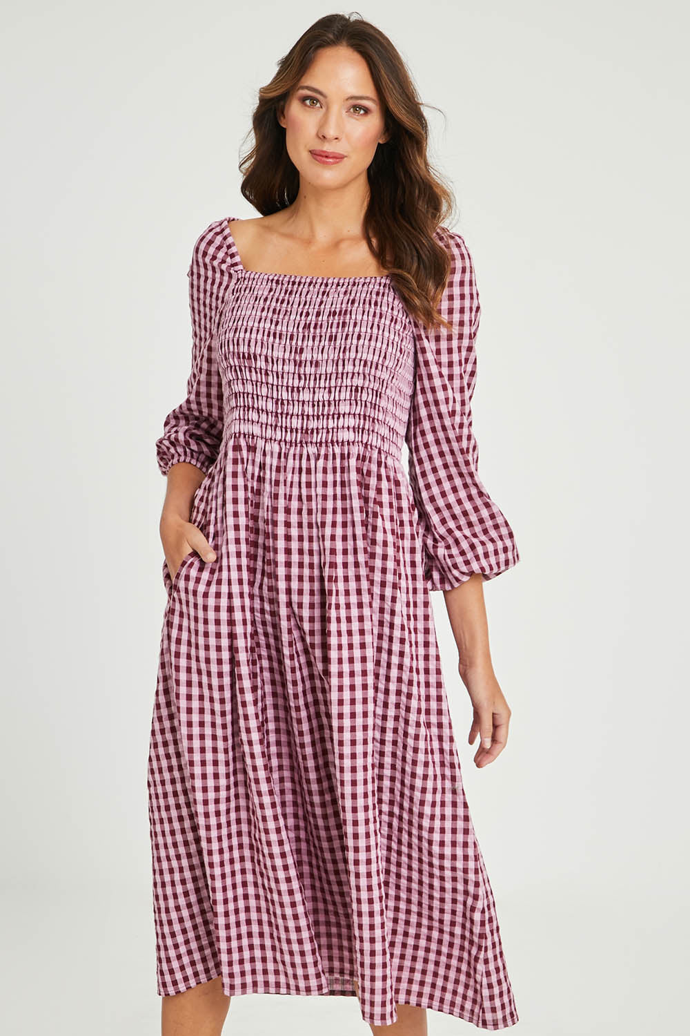 Model Madeline wearing size 10 of the Pippa Check Dress in colour Winecheck (Purple), from the front, cropped image