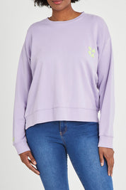 Model Aiyana wearing size 10 of the Young At Heart Crew in colour Purple (Purple), from the front, cropped image