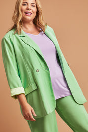 Model Fiona wearing size 16 of the Rhiannon Blazer in colour Meadow (Green), from the front, showing the whole outfit
