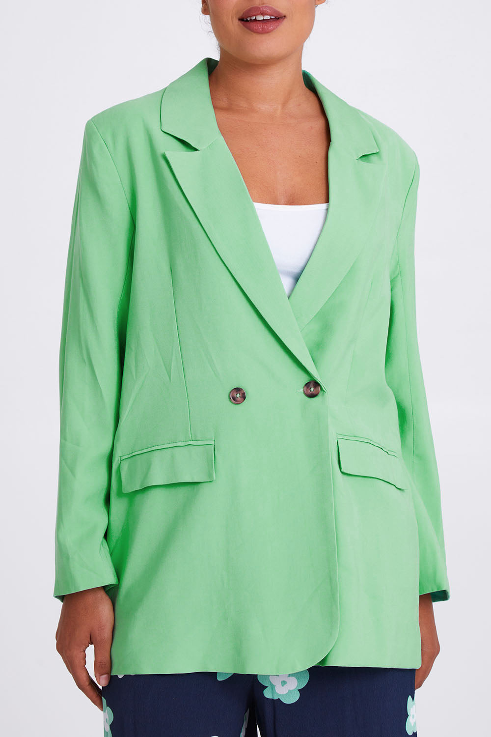 Model Olivia wearing size 10 of the Rhiannon Blazer in colour Meadow (Green), from the front, cropped image