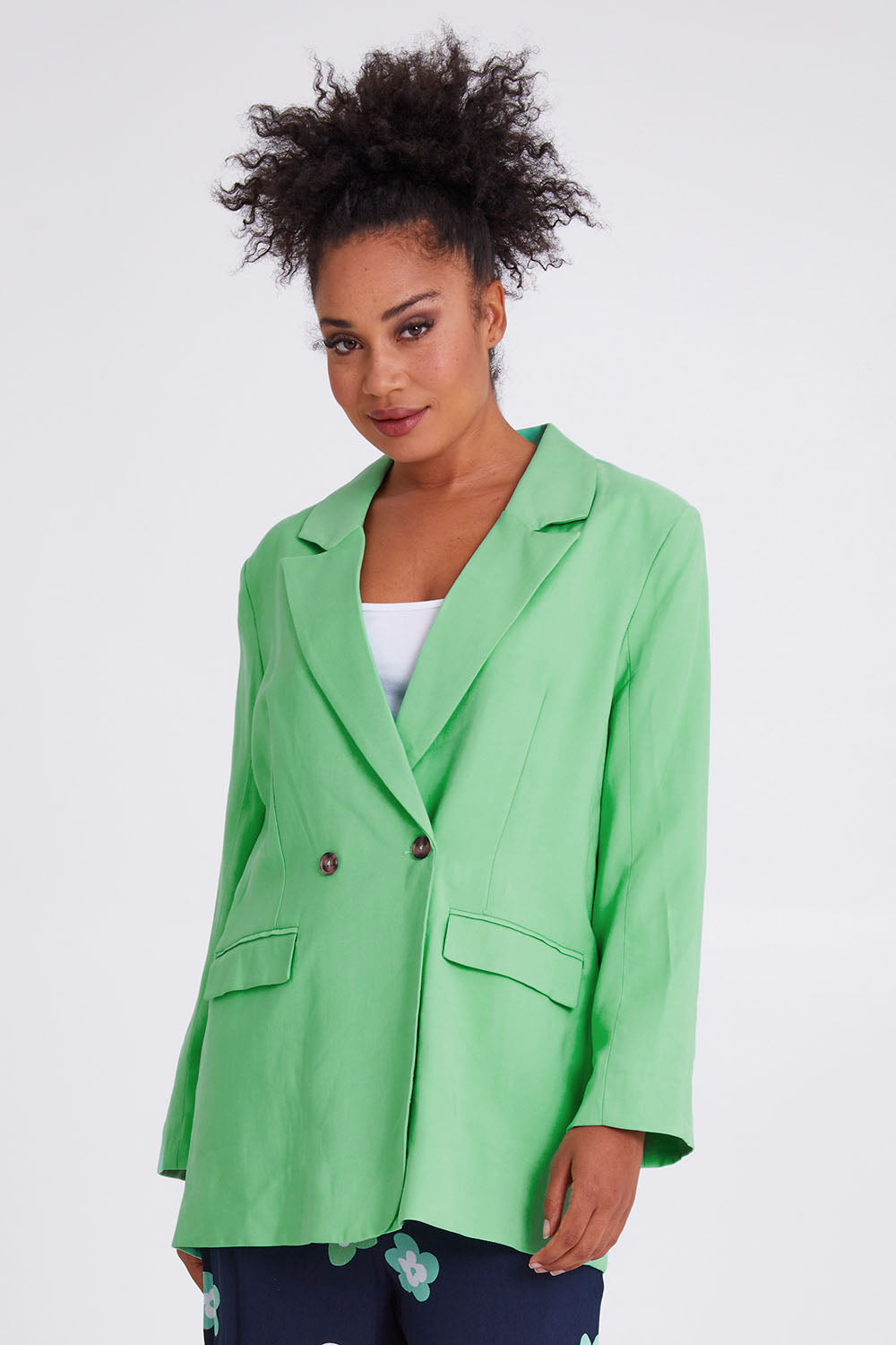 Model Olivia wearing size 10 of the Rhiannon Blazer in colour Meadow (Green), from the front, cropped image