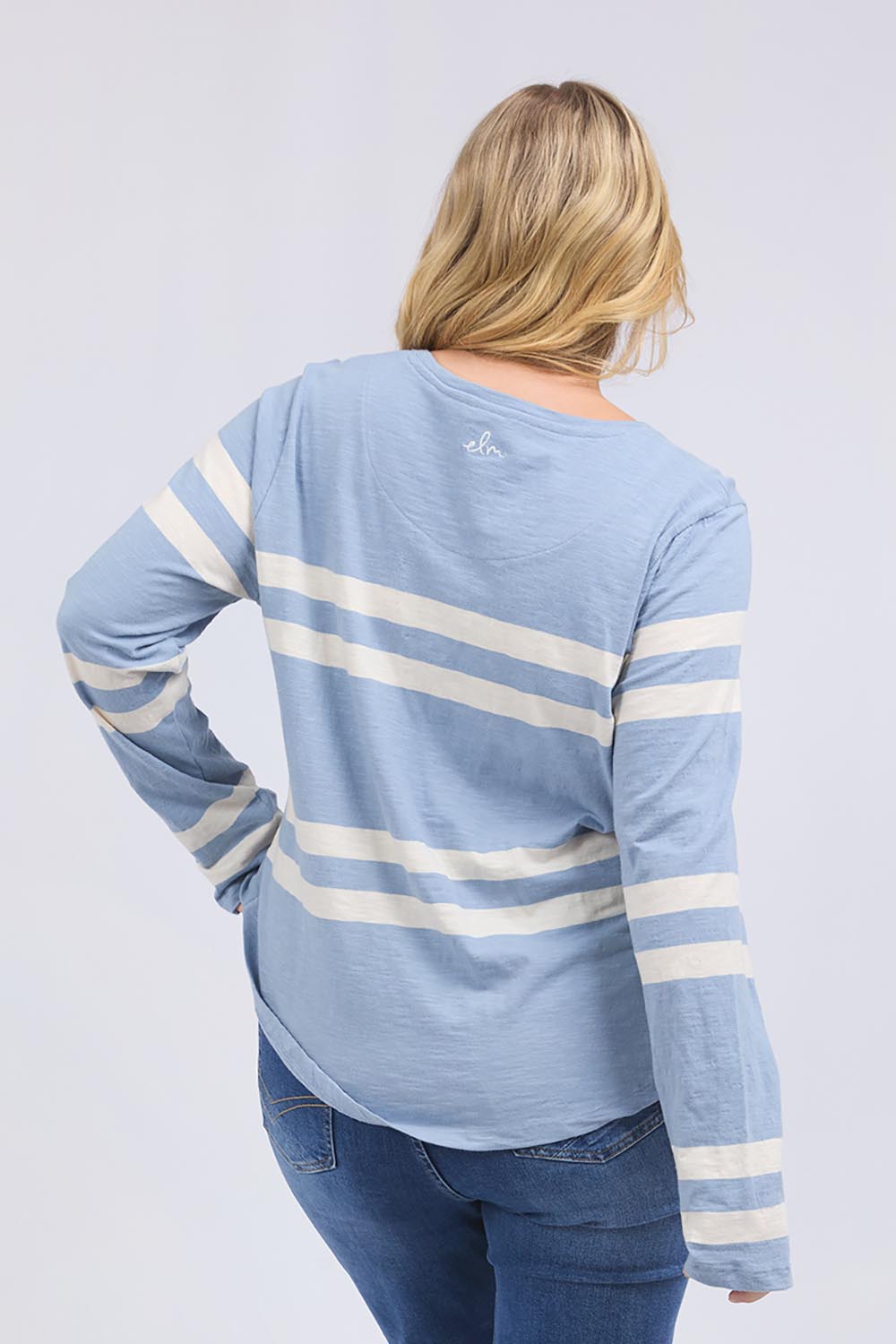 A model wearing the Allegra Long Sleeve Cotton Tee in colour Marshblue (White), from the back