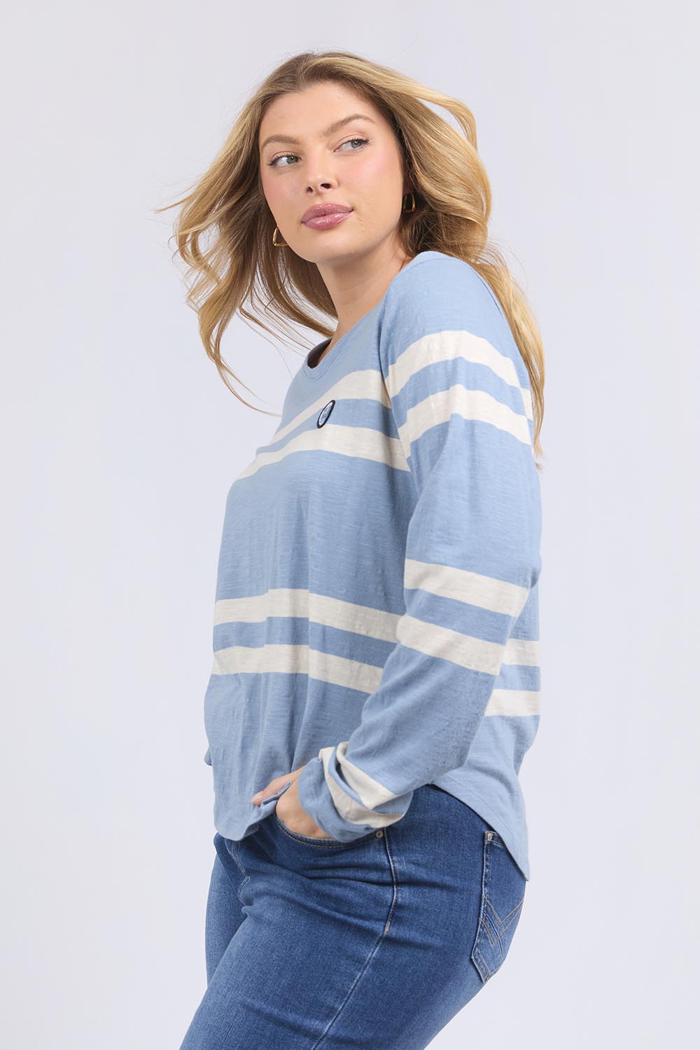 A model wearing the Allegra Long Sleeve Cotton Tee in colour Marshblue (White), from the front, cropped image