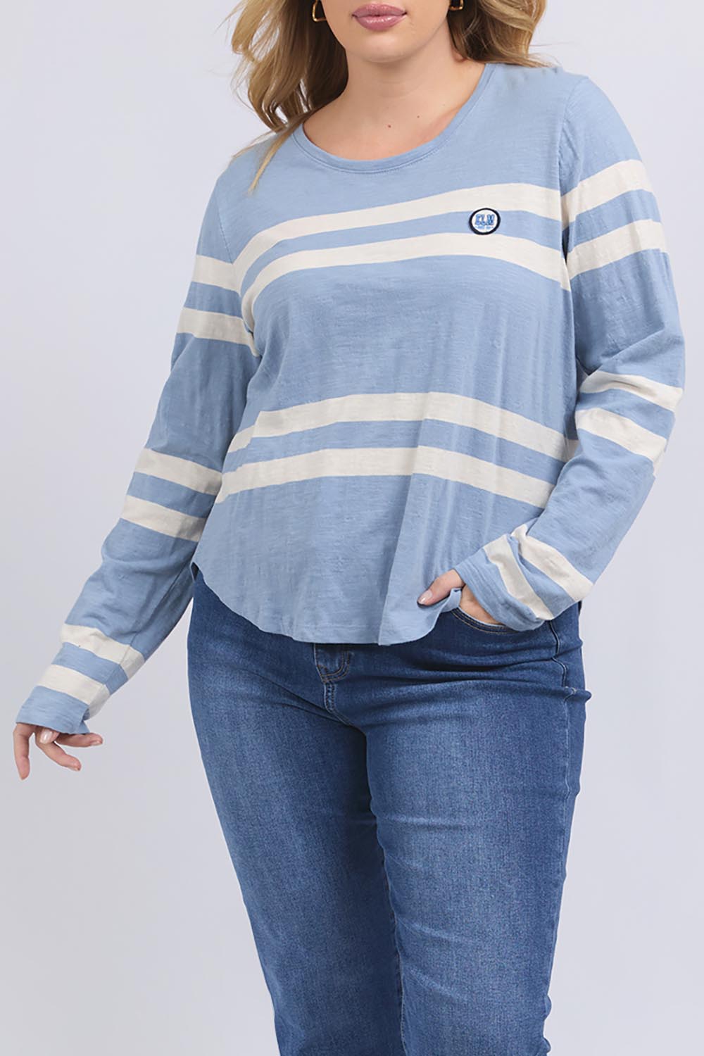 A model wearing the Allegra Long Sleeve Cotton Tee in colour Marshblue (White), from the front, cropped image