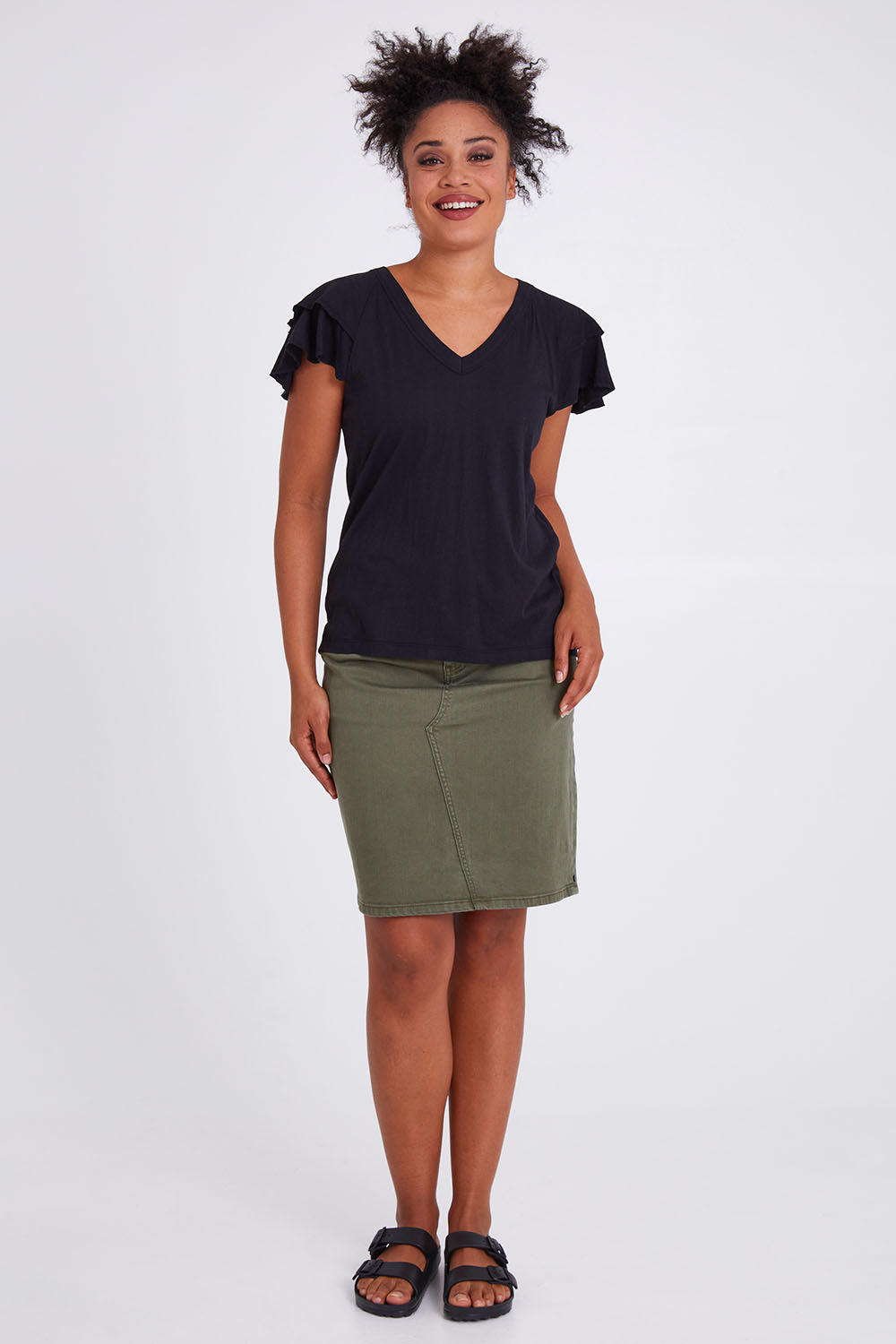Model Olivia wearing size 10 of the Tulip Tee in colour Black (Black), from the front, showing the whole outfit