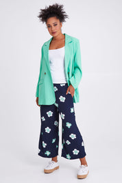 Model Olivia wearing size 10 of the Juno Floral Pant in colour Navyjuno (Blue), from the front, showing the whole outfit